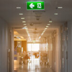 Green,Emergency,Exit,Sign,In,Hospital,Showing,The,Way,To