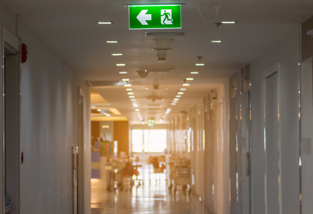 Green,Emergency,Exit,Sign,In,Hospital,Showing,The,Way,To