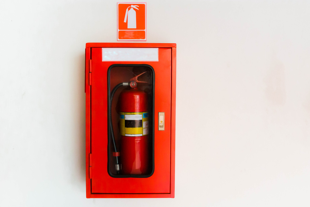 Fire,Extinguisher,In,Red,Cabinet,On,White,Wall,At,Exterior