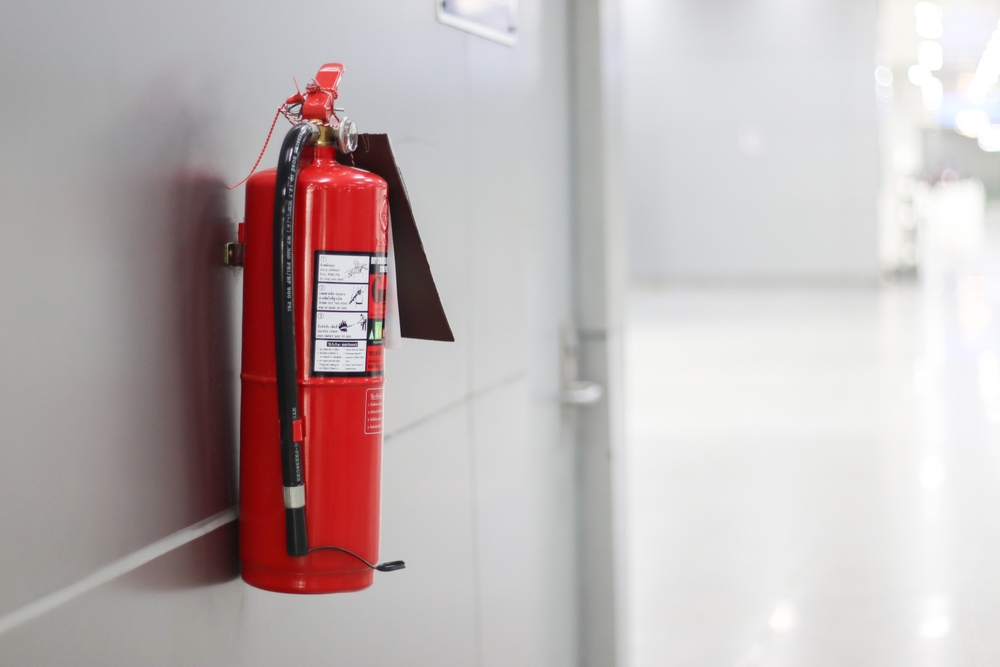 A,Red,Fire,Extinguisher,Hangs,On,The,Wall.