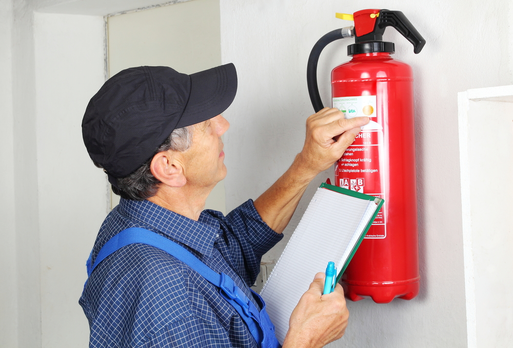 A,Professional,Checking,Afire,Extinguisher